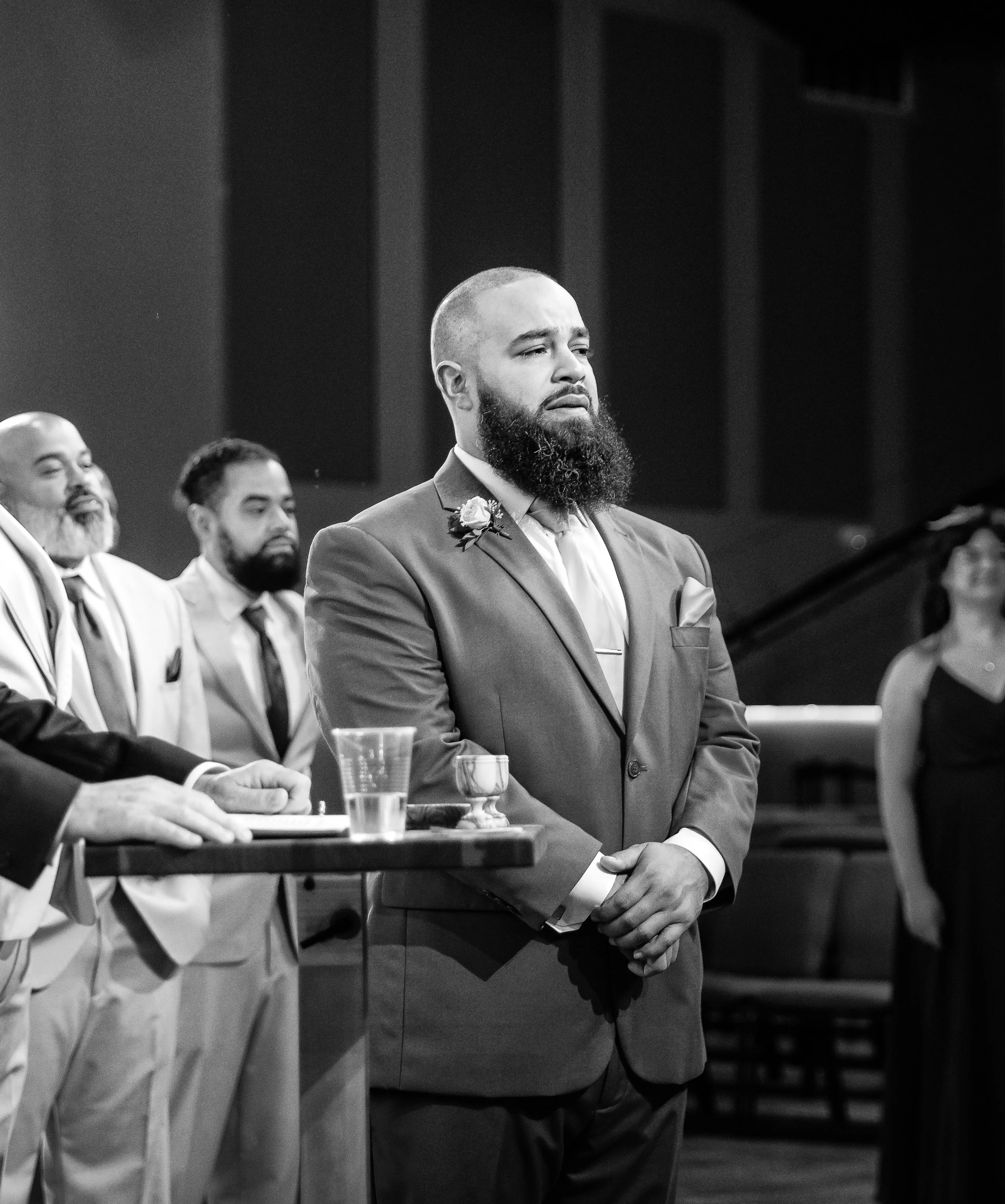 Groom waiting at the altar, black and white ceremony photograph